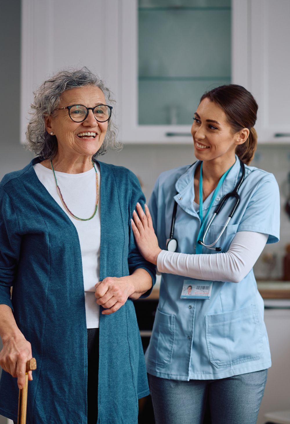 Caregiver Supporting Senior Woman in the Kitchen Caregiver Supporting Senior Woman in the Kitchen