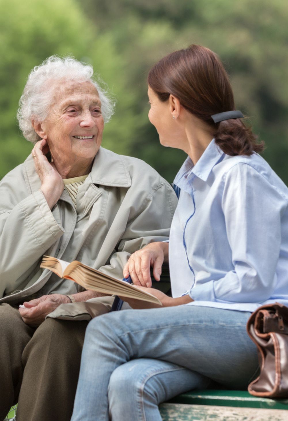 Caregiver reading with an older adult receiving compassionate personal care in Escondido.